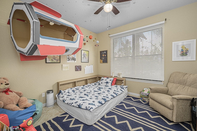 bedroom with baseboards, tile patterned flooring, and a ceiling fan