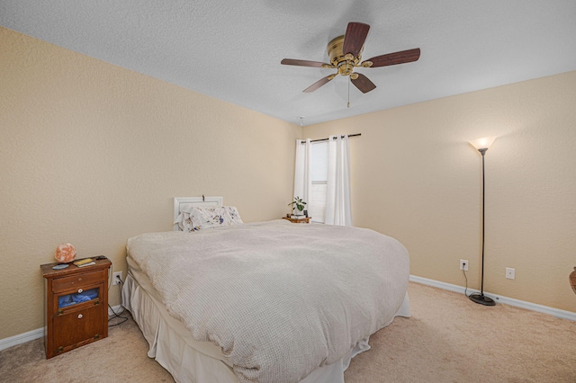 bedroom with baseboards, light carpet, and ceiling fan