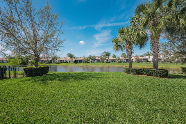 property view of water with fence and a residential view