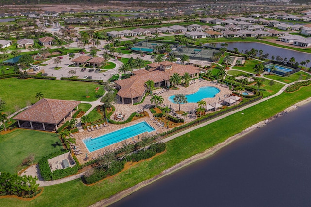birds eye view of property with a water view and a residential view