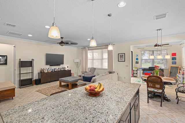 kitchen with open floor plan, a textured ceiling, ceiling fan, and light tile patterned floors