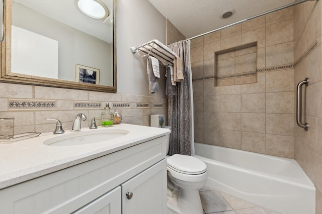 bathroom with tile walls, toilet, shower / bath combo with shower curtain, a textured ceiling, and tile patterned flooring