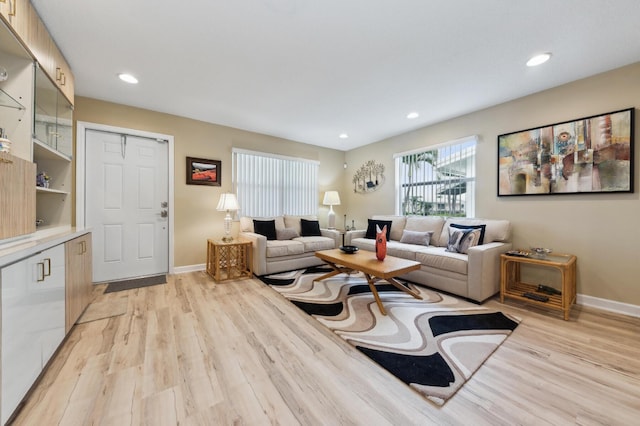 living area with light wood-style floors, recessed lighting, and baseboards