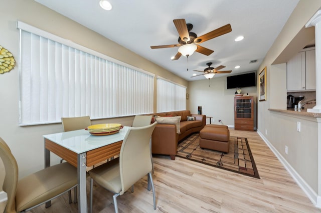 dining room featuring baseboards, recessed lighting, and light wood-style floors