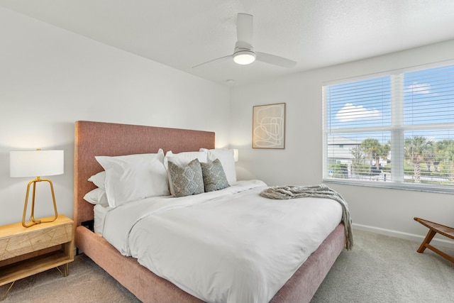 bedroom featuring a ceiling fan, carpet, and baseboards