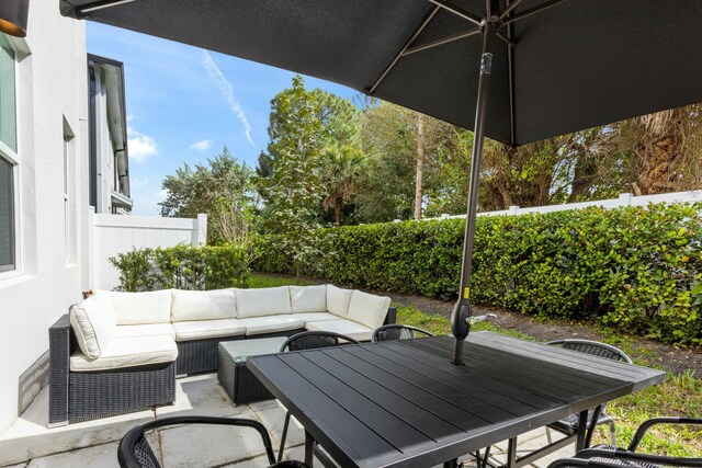 view of patio / terrace featuring outdoor dining area, an outdoor hangout area, and a fenced backyard