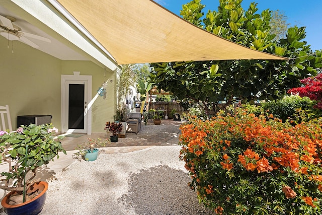 view of patio / terrace with fence and a ceiling fan