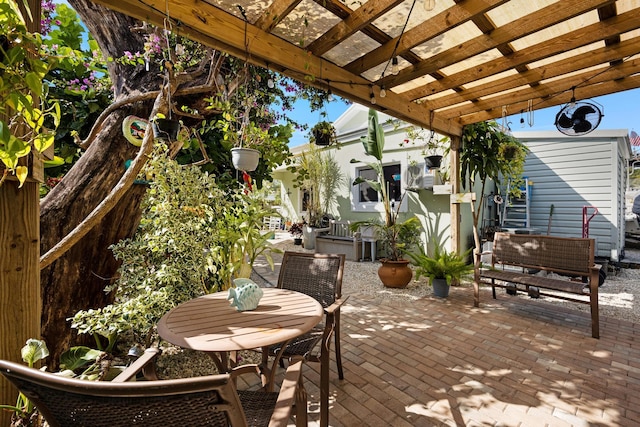 view of patio featuring outdoor dining area and a pergola