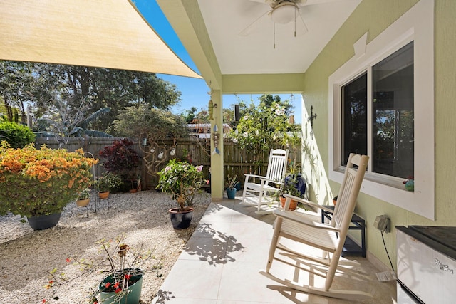 view of patio featuring fence and a ceiling fan