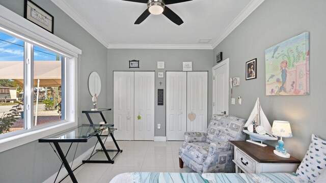 living area featuring ceiling fan, ornamental molding, baseboards, and light tile patterned flooring