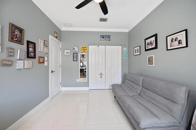 living area featuring light tile patterned floors, ceiling fan, visible vents, baseboards, and ornamental molding