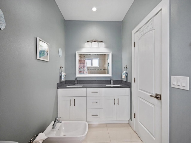 bathroom with double vanity, tile patterned flooring, a sink, and a shower with shower curtain