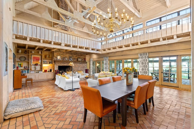 dining area with french doors, brick floor, a high ceiling, and a notable chandelier