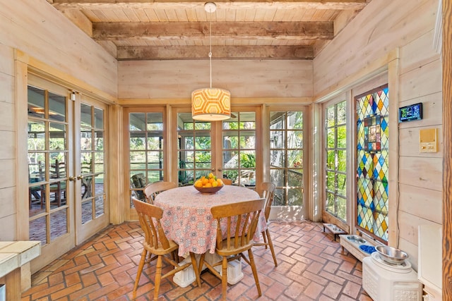 sunroom / solarium with wooden ceiling, plenty of natural light, and beamed ceiling