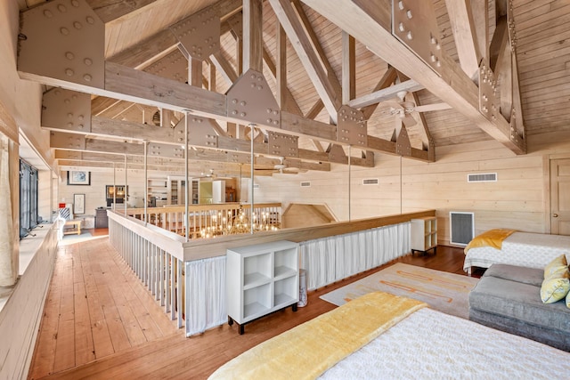 interior space with wooden ceiling, wood walls, beam ceiling, and hardwood / wood-style floors