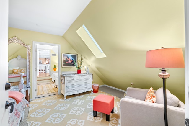 interior space featuring carpet floors, baseboards, and lofted ceiling with skylight