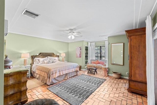 bedroom featuring baseboards, visible vents, a ceiling fan, ornamental molding, and brick floor