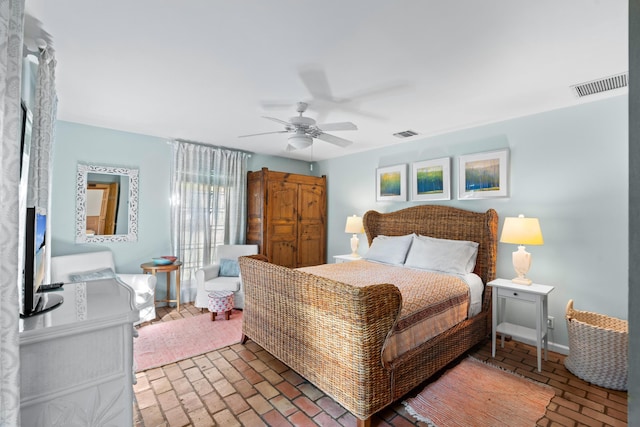 bedroom with brick floor, ceiling fan, and visible vents