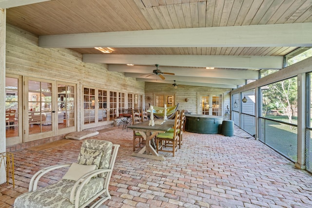 sunroom featuring lofted ceiling with beams, wood ceiling, and a ceiling fan