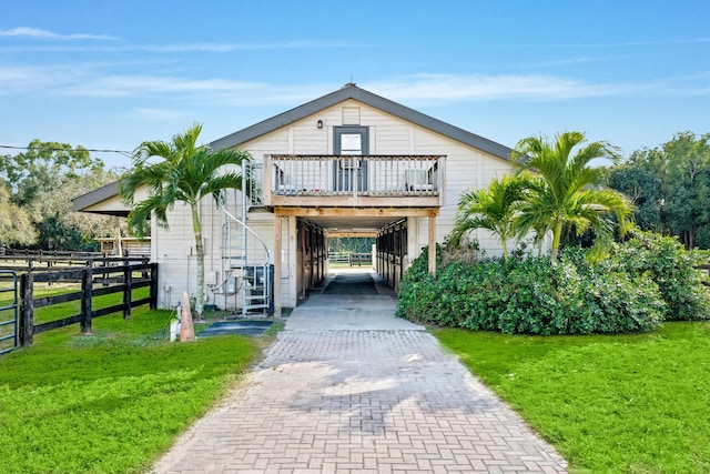 view of front of property with a carport, decorative driveway, and a front lawn