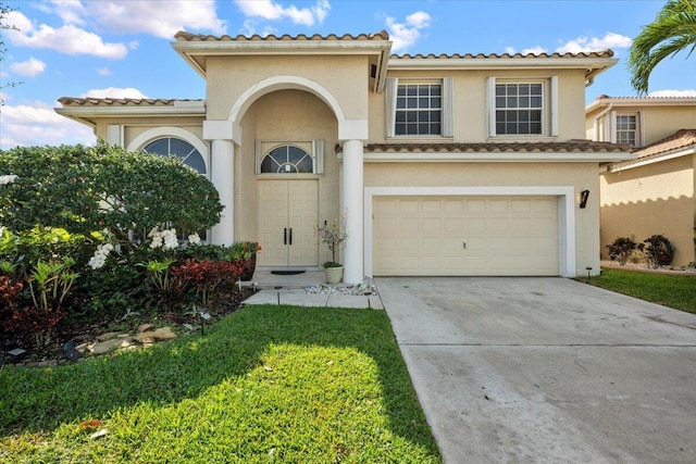 mediterranean / spanish-style house with a garage, driveway, and stucco siding