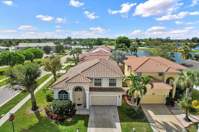 view of front of home with driveway, a tiled roof, and stucco siding