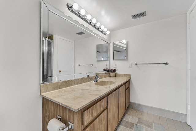 bathroom with tile patterned floors, baseboards, visible vents, and vanity