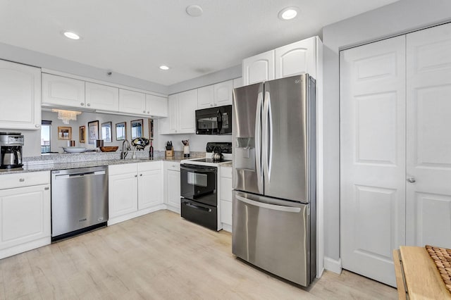 kitchen with light wood-style flooring, recessed lighting, stainless steel appliances, a sink, and white cabinetry