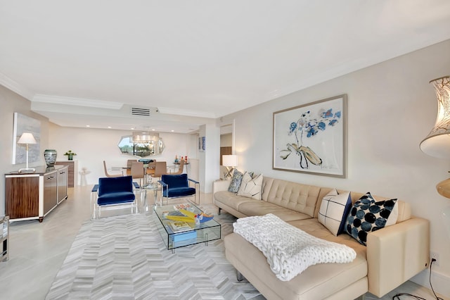 living room featuring visible vents, a chandelier, and crown molding