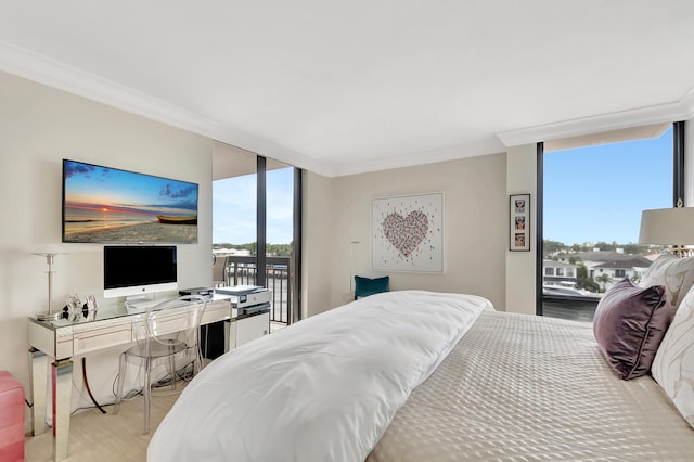 bedroom with access to exterior, wood finished floors, a wall of windows, and ornamental molding