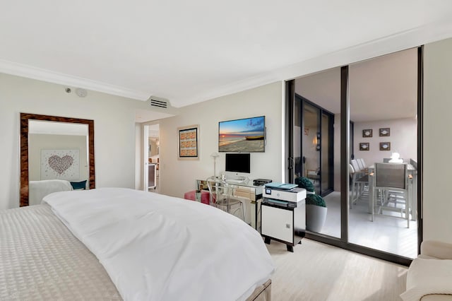 bedroom featuring visible vents, ornamental molding, floor to ceiling windows, and light wood finished floors