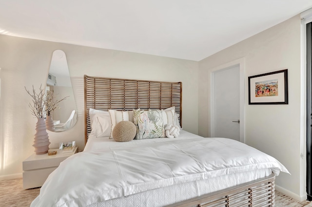 bedroom with baseboards and light wood-style floors