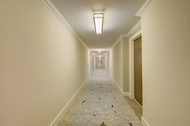 hallway with crown molding and baseboards