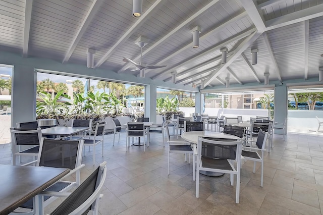 view of patio with outdoor dining space and a ceiling fan