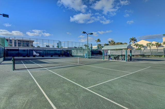 view of tennis court with fence