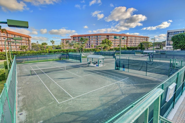 view of tennis court featuring fence