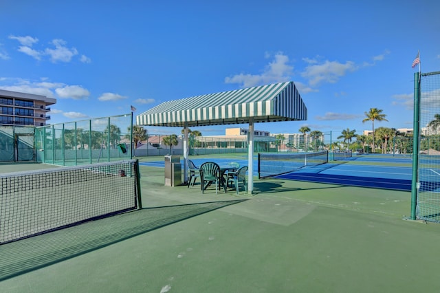 view of tennis court featuring fence