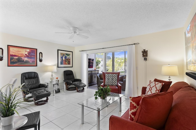 living area featuring a textured ceiling, ceiling fan, and light tile patterned flooring