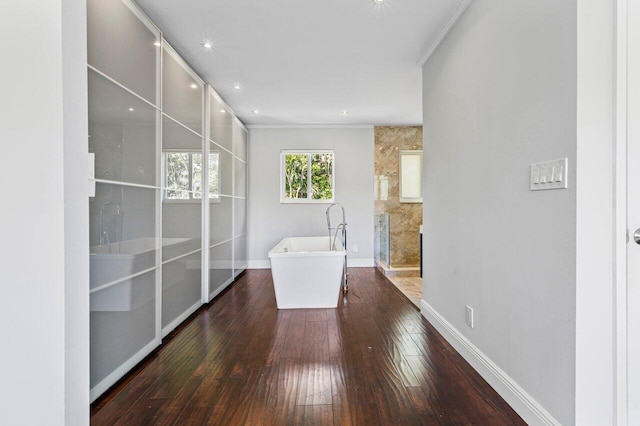 spare room with dark wood-style floors, ornamental molding, and baseboards