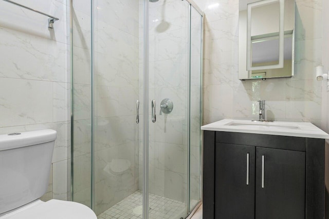 bathroom with toilet, a shower stall, and tile walls