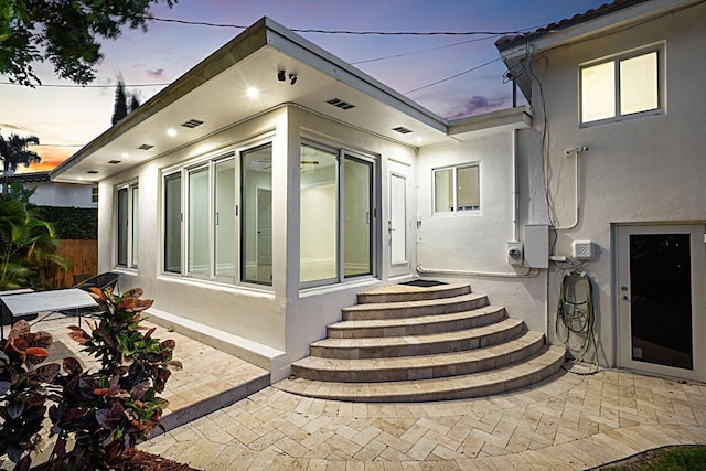 exterior space with a patio area and stucco siding