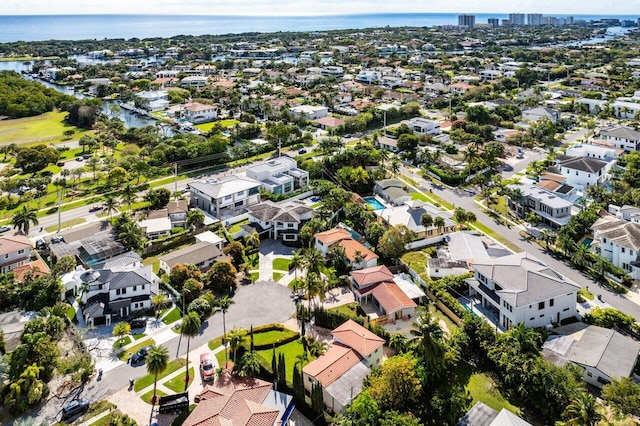 drone / aerial view featuring a water view and a residential view