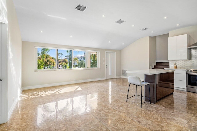 kitchen with electric stove, visible vents, and white cabinets