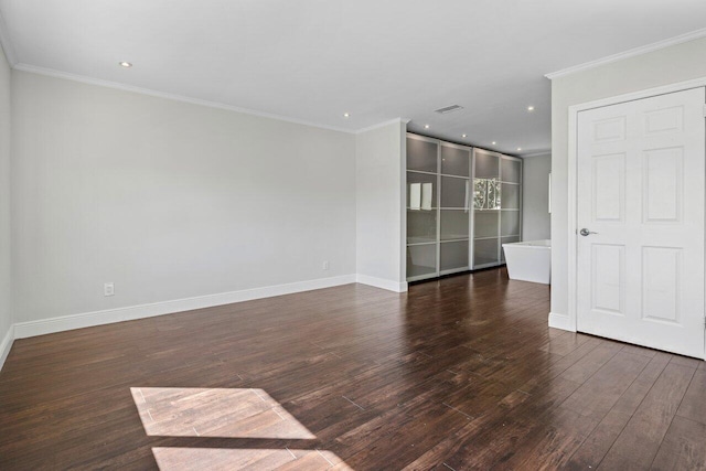 spare room with recessed lighting, wood finished floors, visible vents, baseboards, and ornamental molding