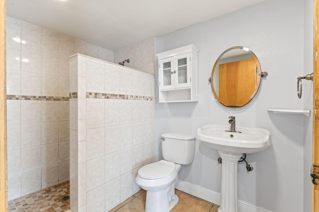 full bath featuring tile patterned floors, baseboards, toilet, and a walk in shower