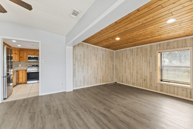 unfurnished living room with visible vents, baseboards, wooden ceiling, light wood-style flooring, and ceiling fan