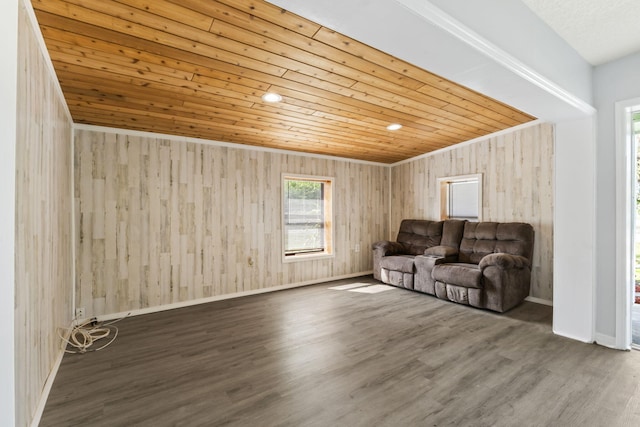 unfurnished living room with wooden ceiling, wood finished floors, and baseboards