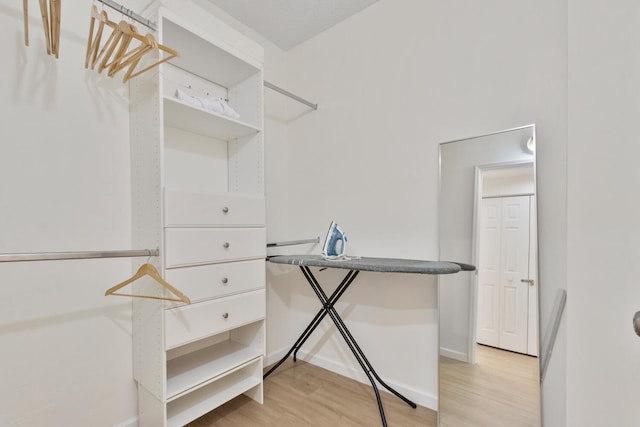 walk in closet featuring light wood-style flooring