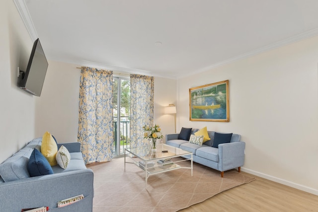 living room with baseboards, ornamental molding, and wood finished floors