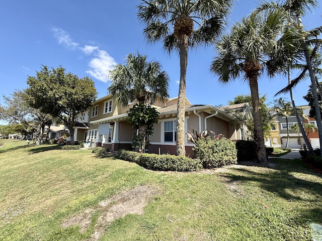 view of property exterior with a lawn and stucco siding